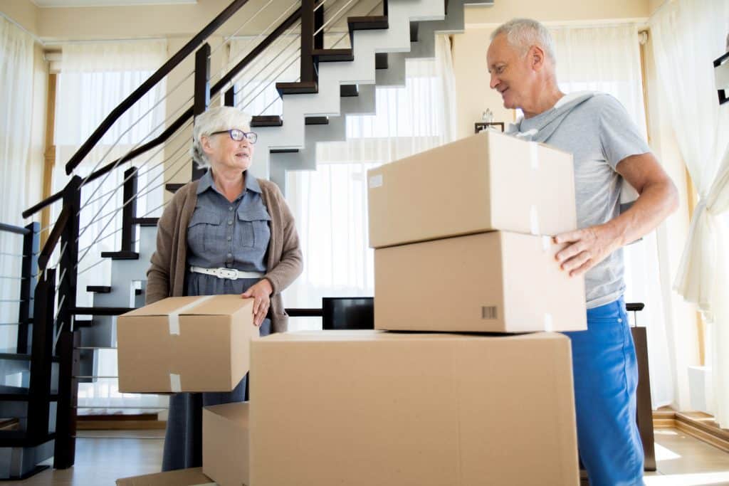 Senior Couple Moving House. Packing boxes.